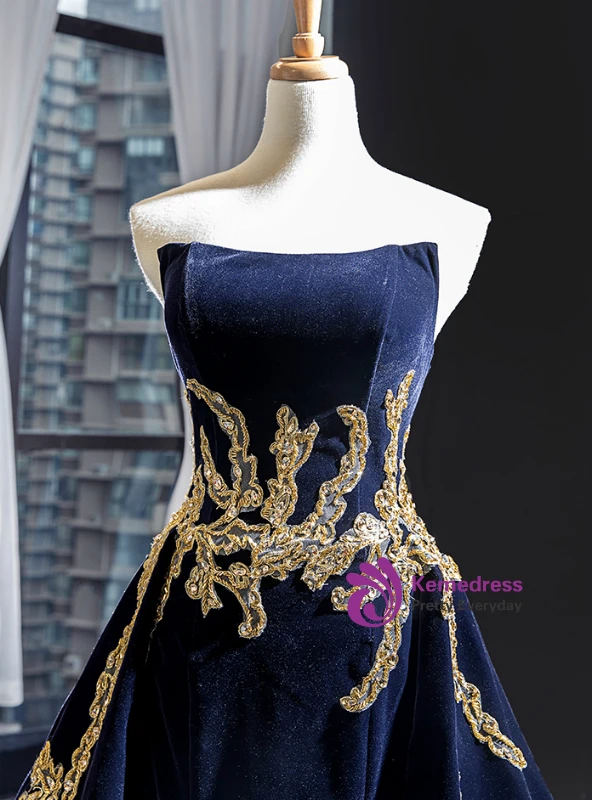Close detail of navy blue velvet strapless prom dress with gold appliqué and beading