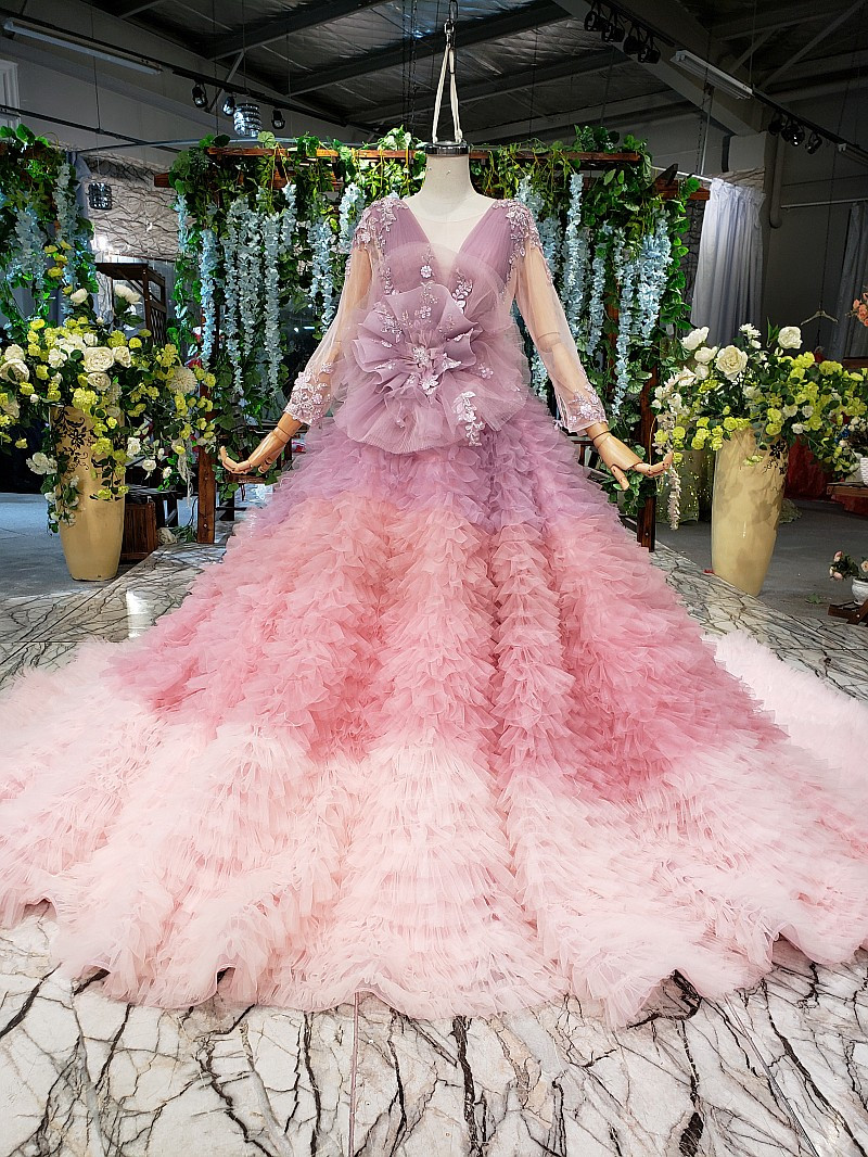 Pink floral appliqué wedding gown with long sleeves and full tulle skirt