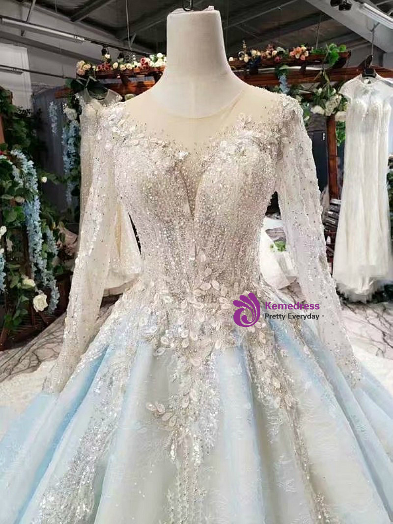 Light blue wedding dress with open-back appearance, long sleeves and full tulle ball gown