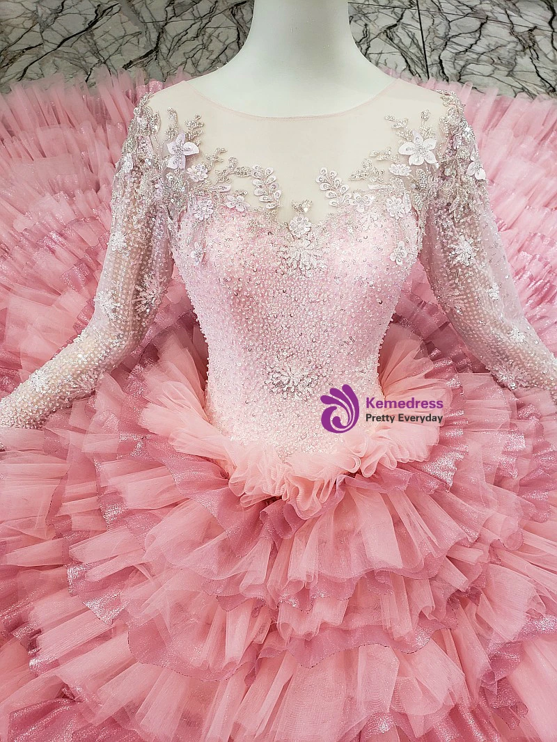 Pink full tulle ball gown wedding dress with long sleeves and ornamental bodice