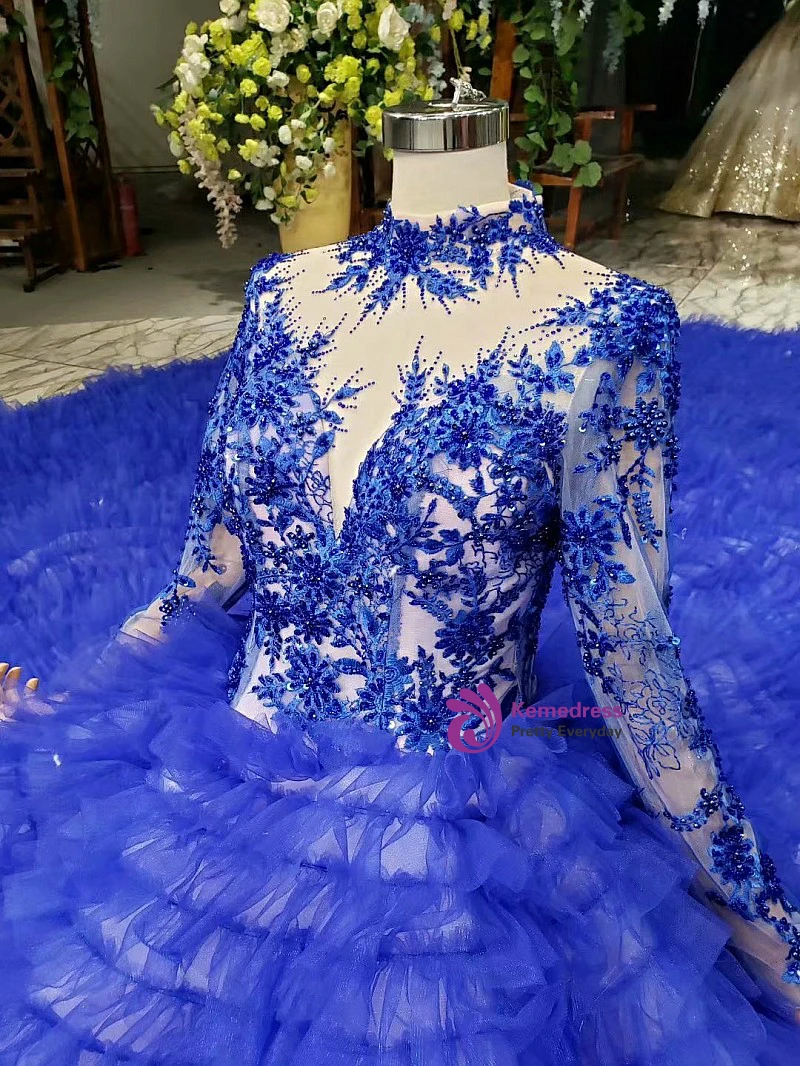 Blue beaded ball gown showing long sleeves, lace-up back and sweeping train
