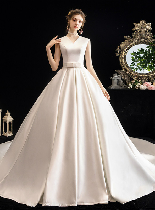 White satin V-neck sleeveless ball gown wedding dress with waist bow and cathedral train