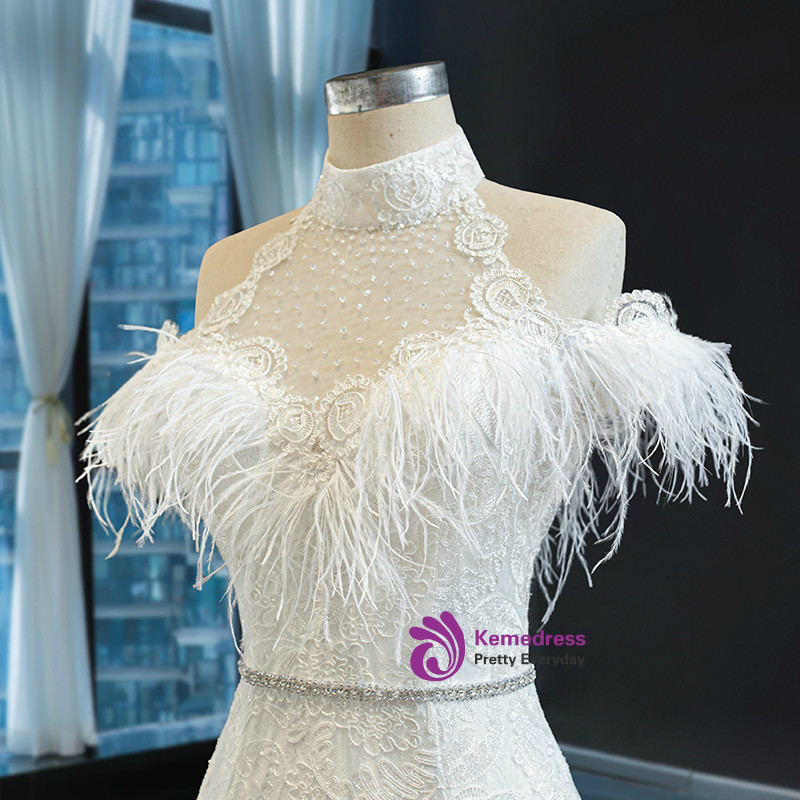 White lace up back mermaid dress with feather detail and floor length skirt