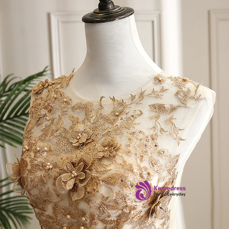 Champagne tulle quinceañera dress with gold floral appliques and beading detail