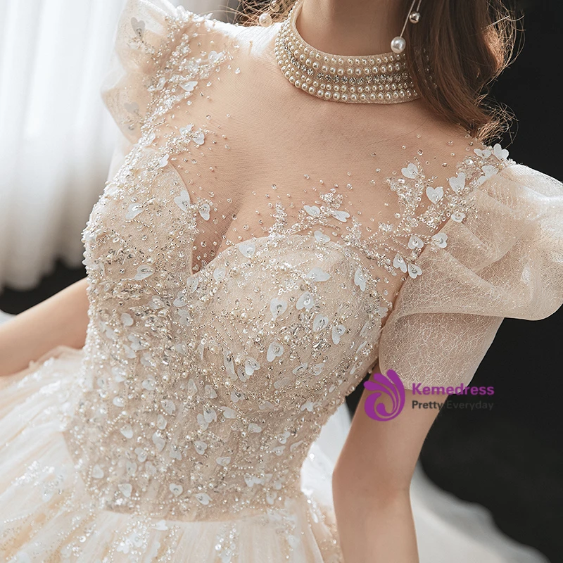 Champagne tulle wedding dress with crystal beading and puff sleeves detail