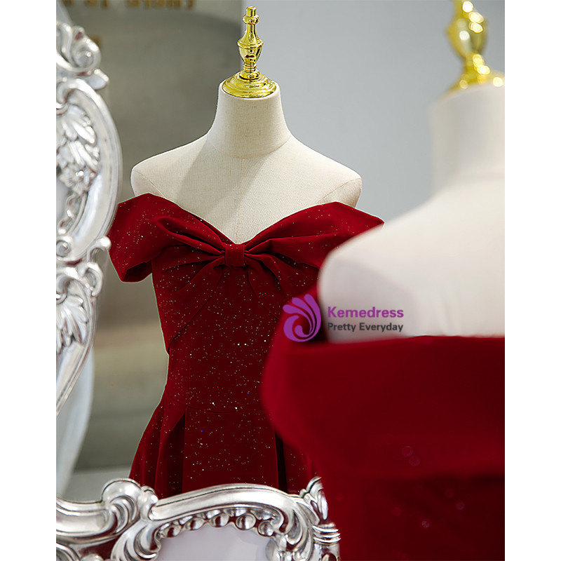 Burgundy prom gown with off the shoulder neckline and oversized bow