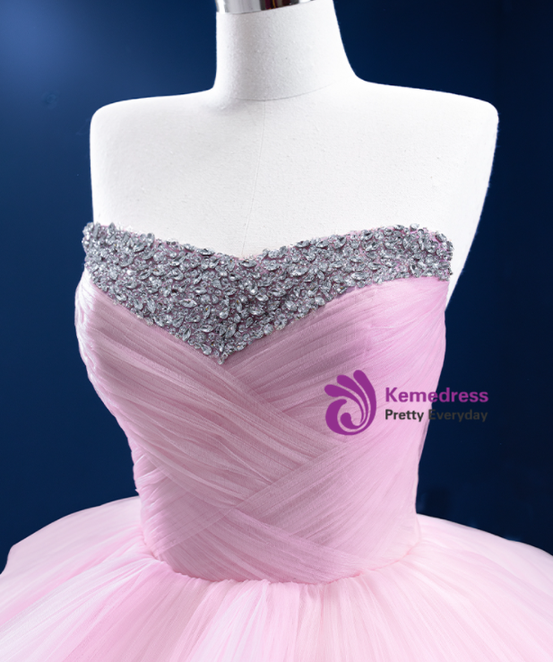 Close detail of layered light pink tulle and crystal embellishment on a romantic ball gown