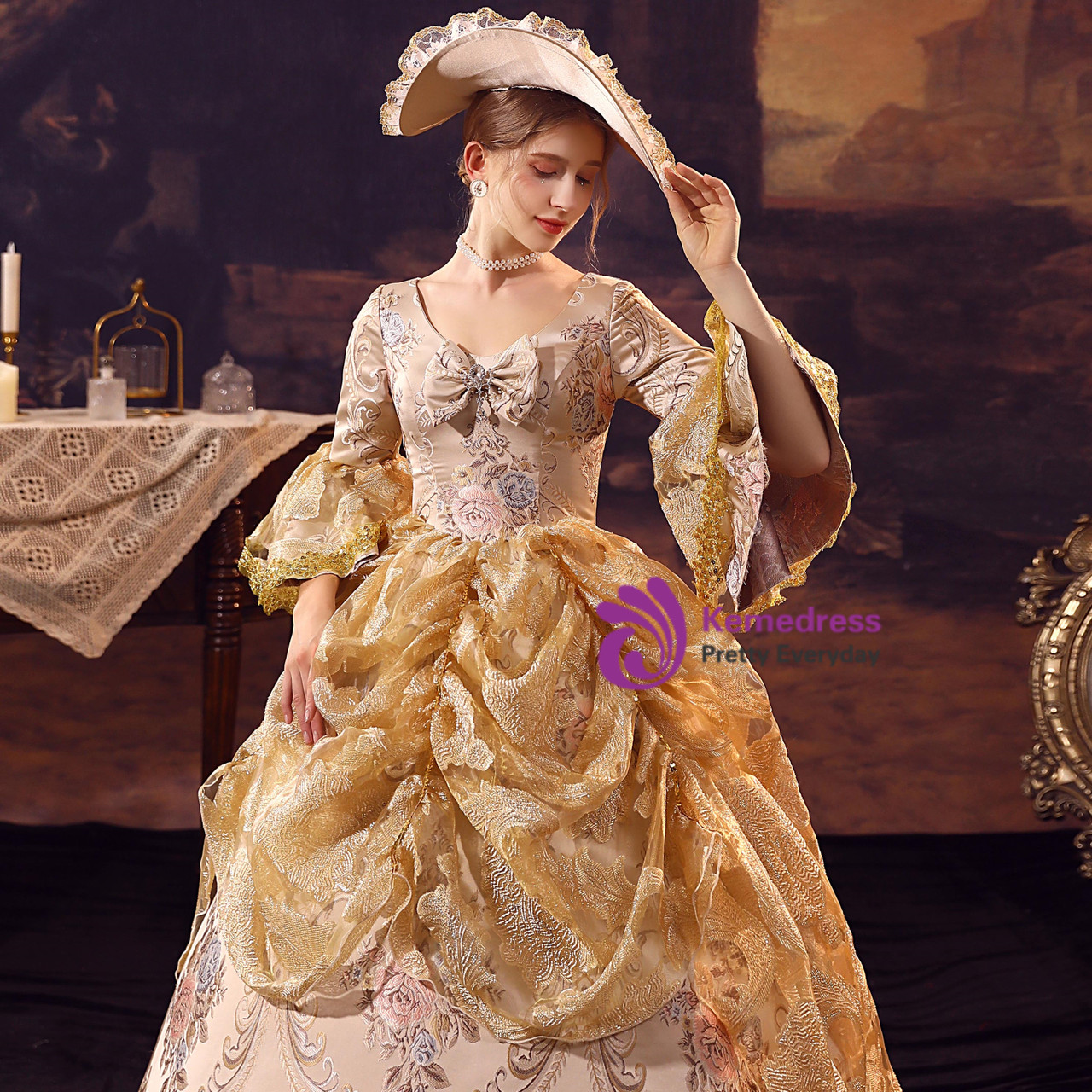 Champagne gold Rococo Baroque dress detail showing ornate embroidery, satin bodice, bell sleeves and gold lace