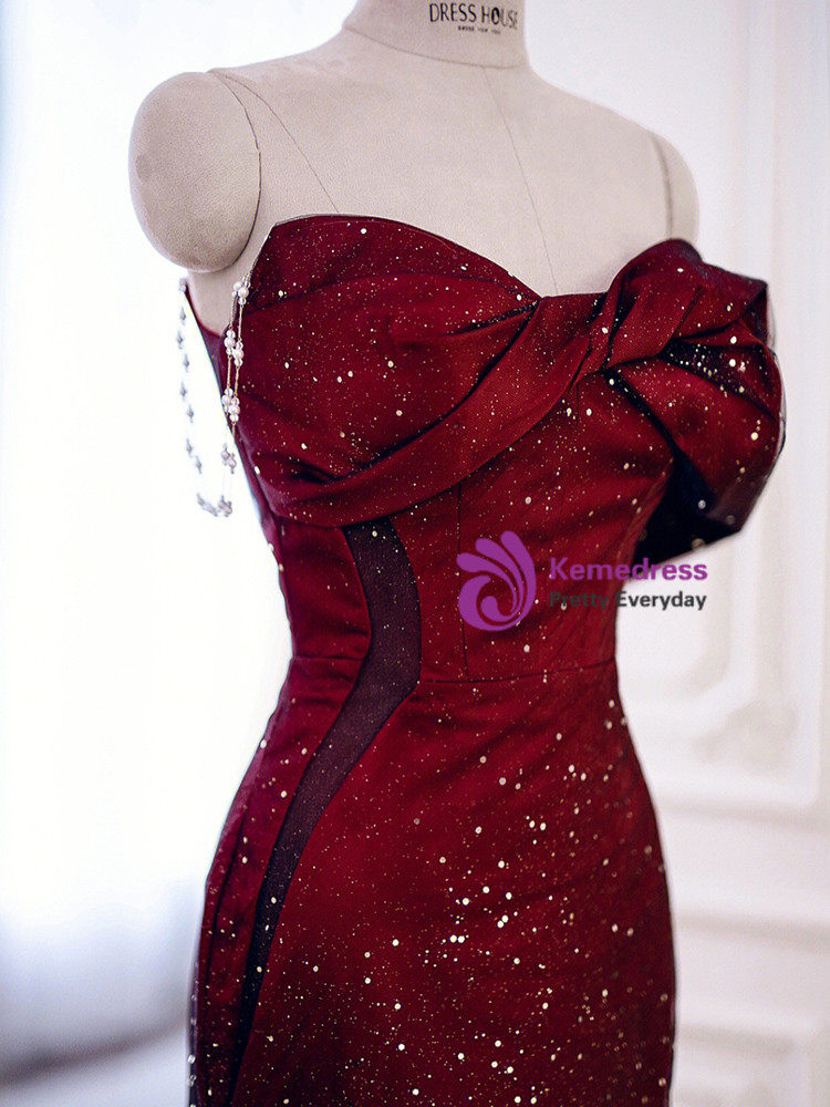 Close up detail of burgundy glitter prom dress with black tulle, off shoulder draping and bow detail