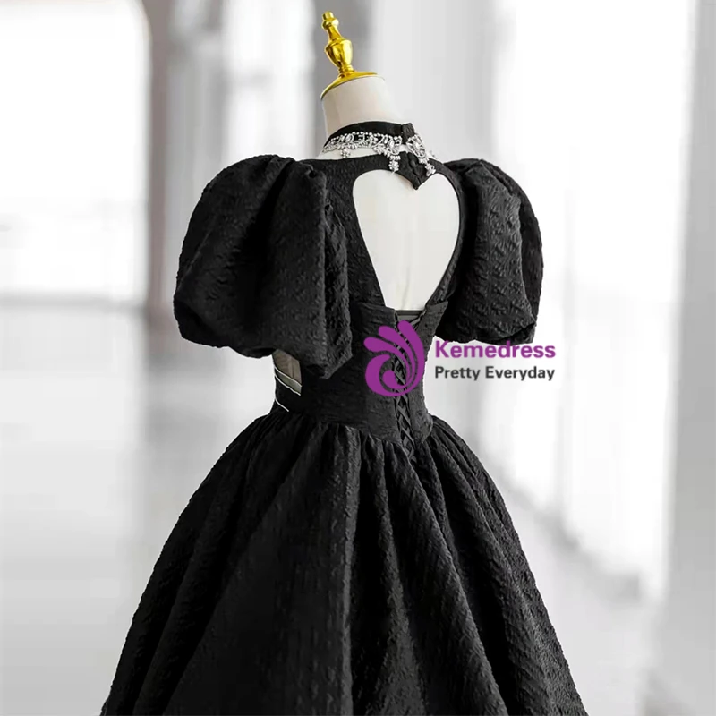 Black prom dress with heart shaped back and voluminous puff sleeves