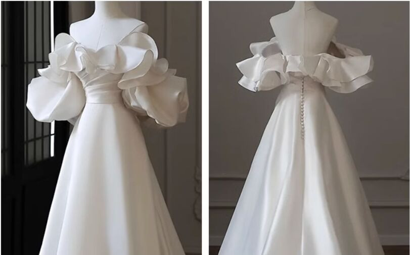 White satin wedding dress with off the shoulder ruffles and full A line skirt