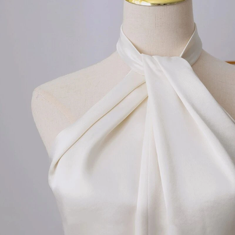 Ivory satin halter wedding dress with twisted neckline and open back detail