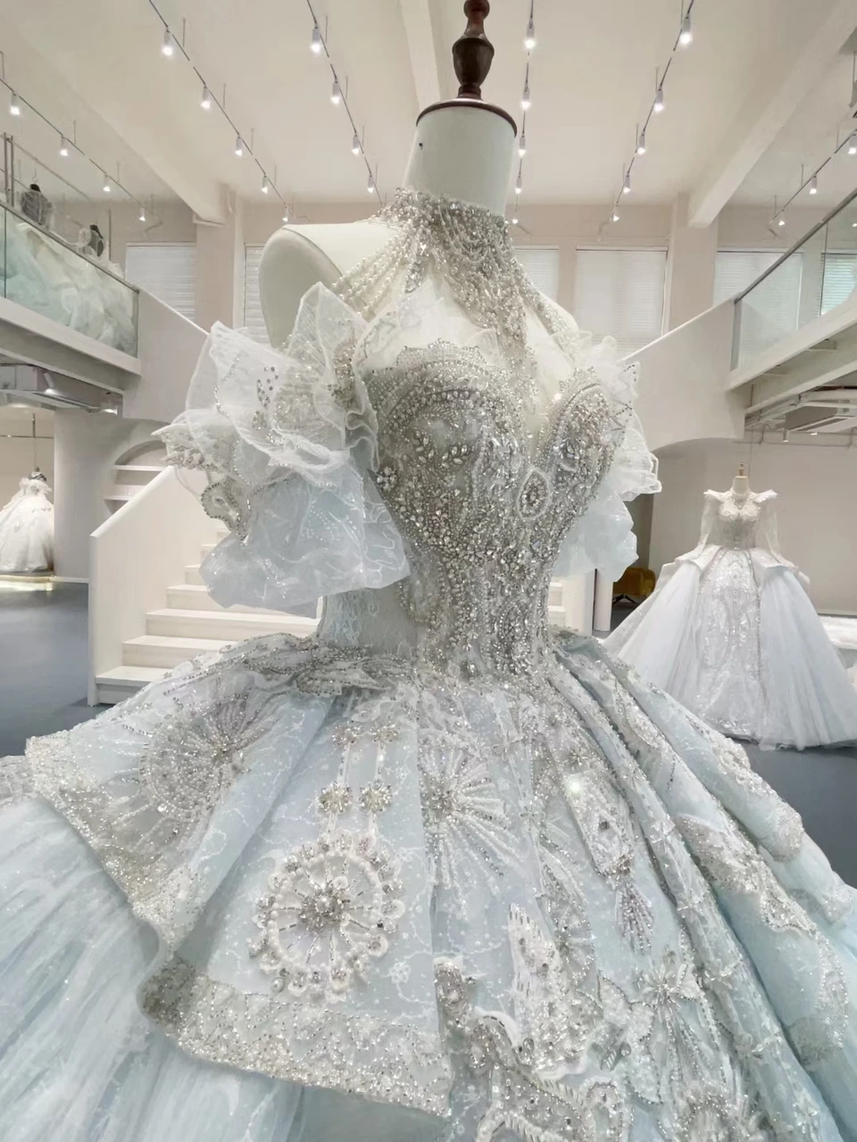 Luxury ball gown wedding dress with intricate beading, lace appliques and layered tulle