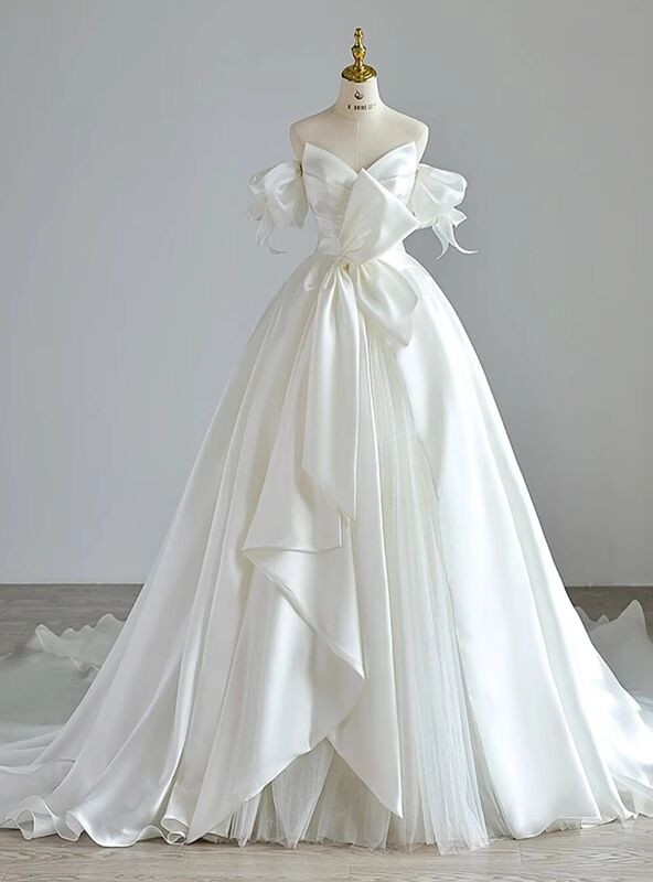 White satin A line wedding dress with strapless sweetheart bodice and detachable puff sleeves