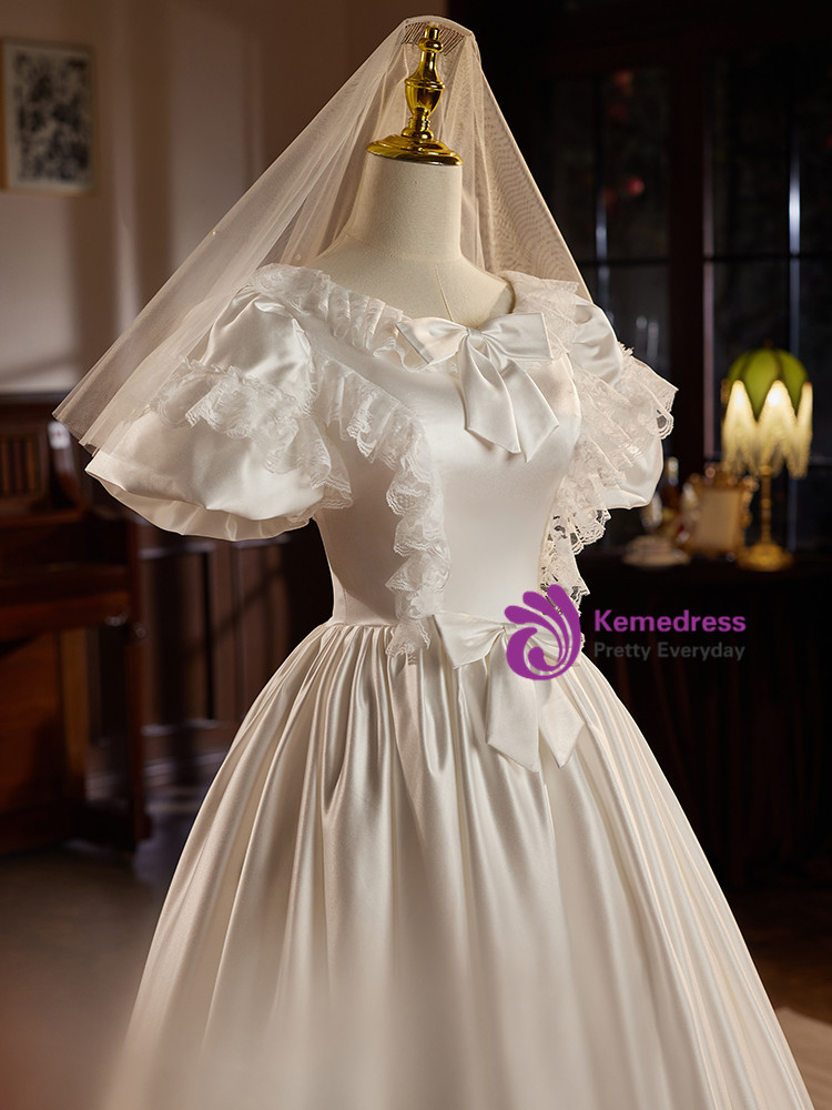 Ivory satin vintage wedding dress with puff sleeves, bows and lace trim