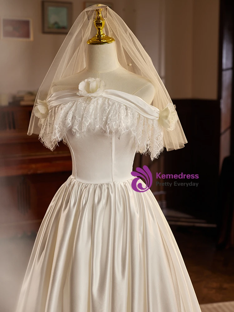 White satin lace off the shoulder wedding dress with fabric roses and corset bodice detail