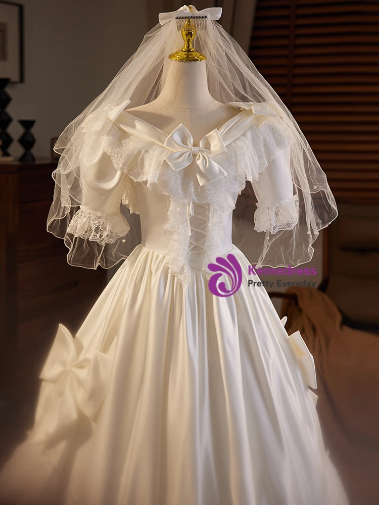 Close up detail of lace bow short sleeve V neck satin wedding dress bodice