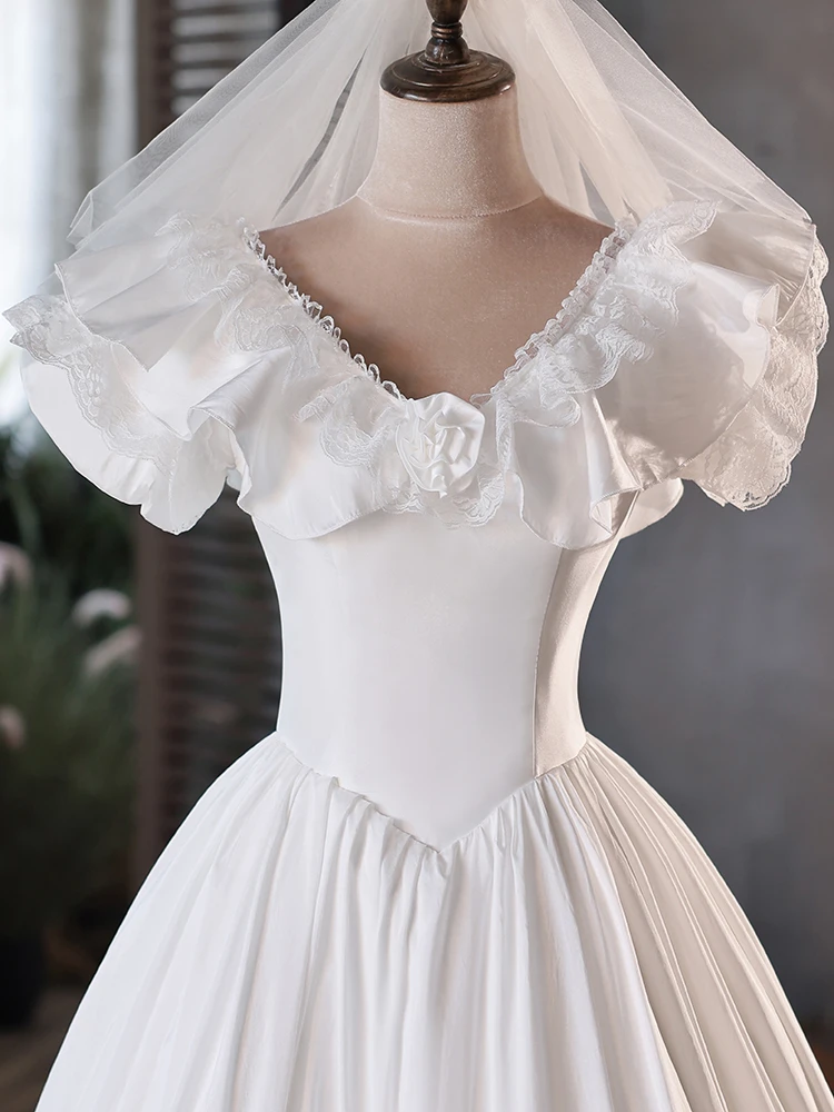 Vintage white satin lace V neck wedding dress detail with ruffle neckline and fabric rose