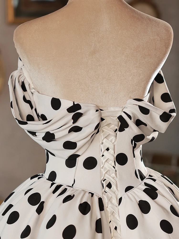 White satin polka dot off the shoulder wedding dress with puff sleeves, bows and full midi ball gown skirt