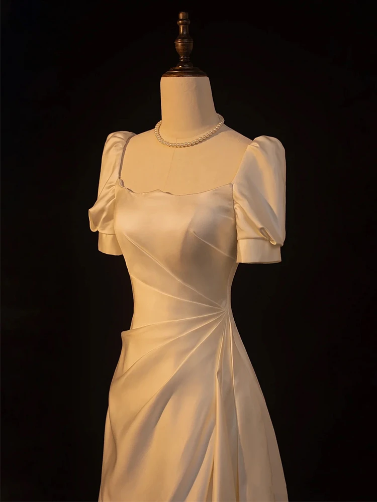 Ivory satin wedding dress twisted pleated bodice and puff sleeve detail