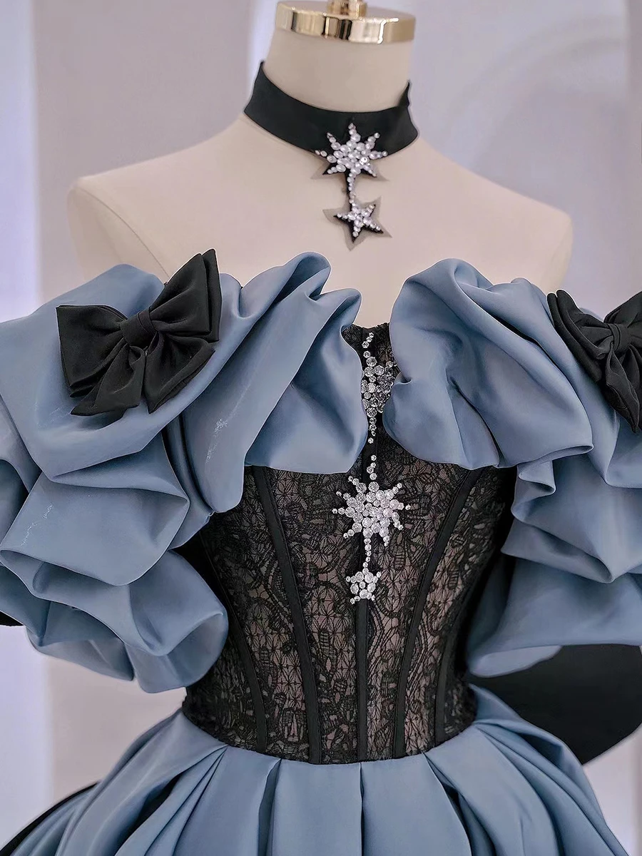 Blue satin prom dress with black floral lace bodice and star crystal embellishment detail