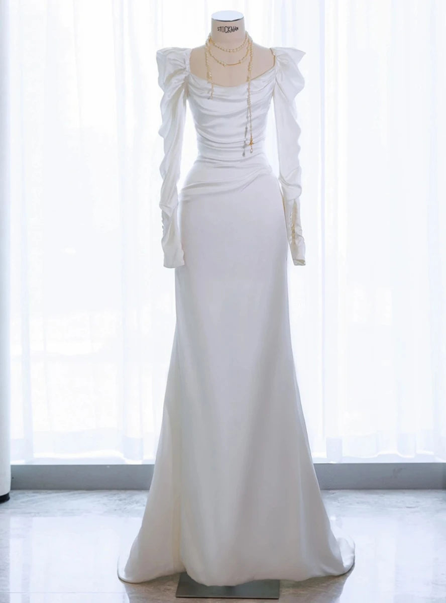 White satin mermaid wedding dress with square neckline gathered shoulders pleated bodice and long sleeves