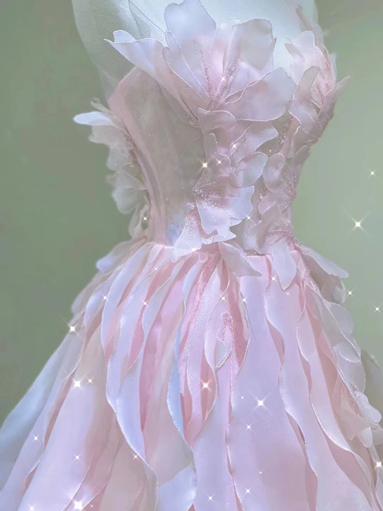 Pink tulle prom dress with dimensional floral appliques and layered petal details