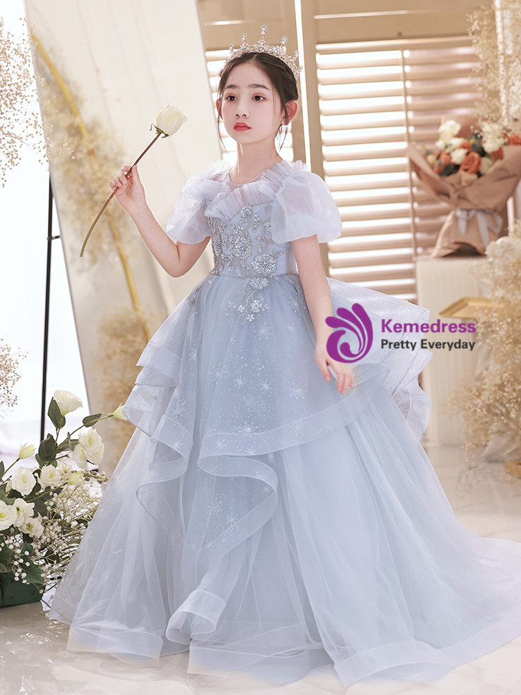 Blue floor length A-line flower girl dress with cascading tulle ruffles and snowflake motifs