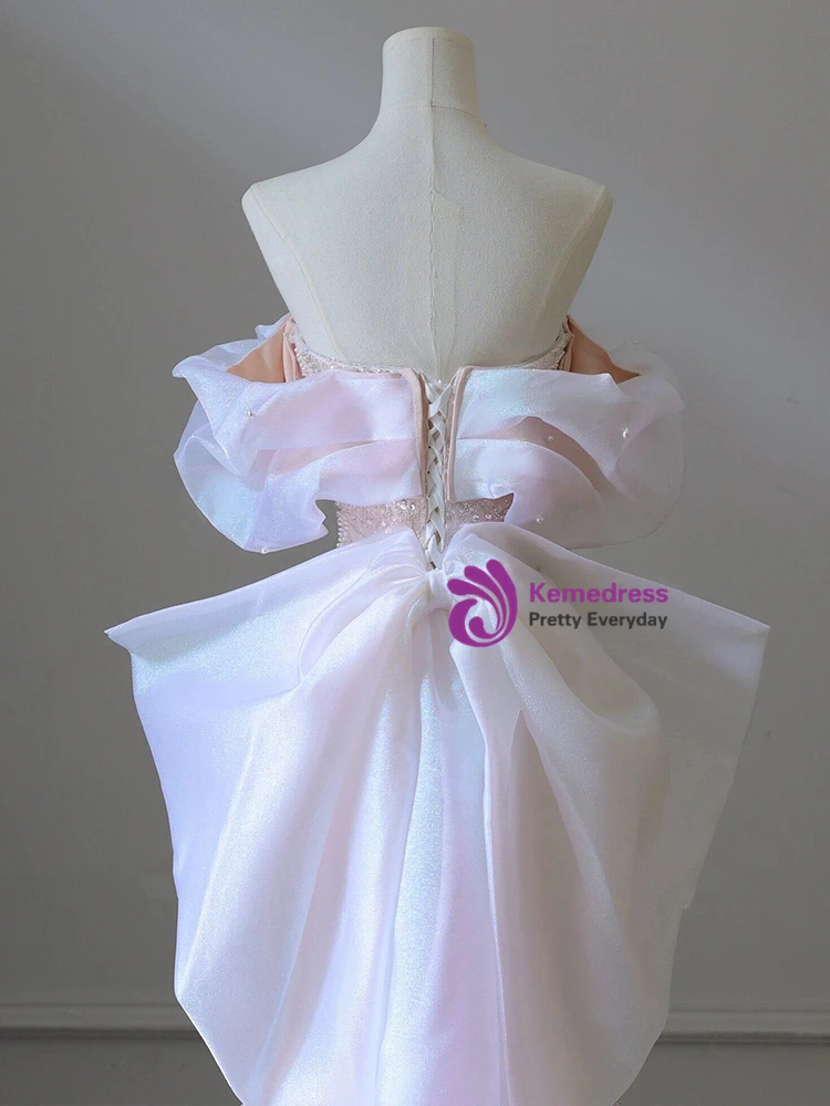Close view of pink sequin prom gown with pearl embellishment and strapless bodice