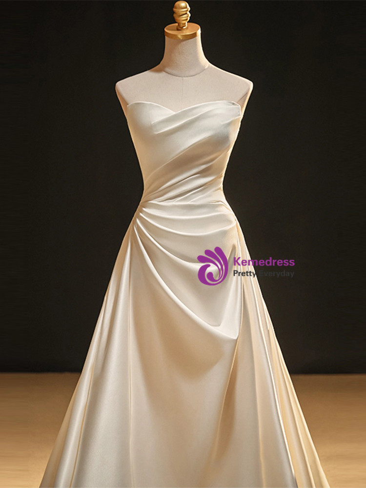 Ivory white satin sweetheart wedding dress with oversized statement bow and lace up back
