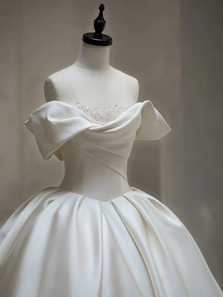 Ivory satin off shoulder wedding dress detail