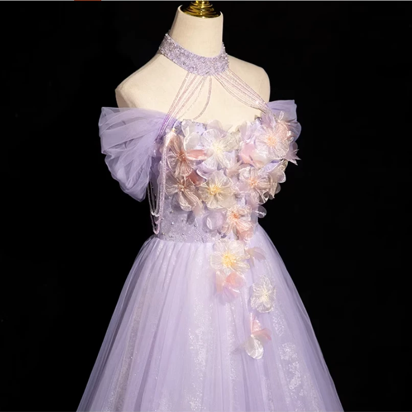 Back view of purple lace-up tulle prom dress with halter neckline