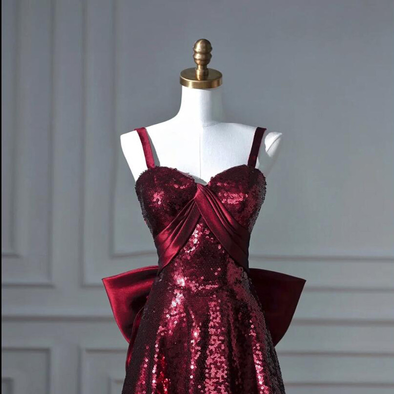Burgundy sequin formal gown with large bow at waist and full A line skirt