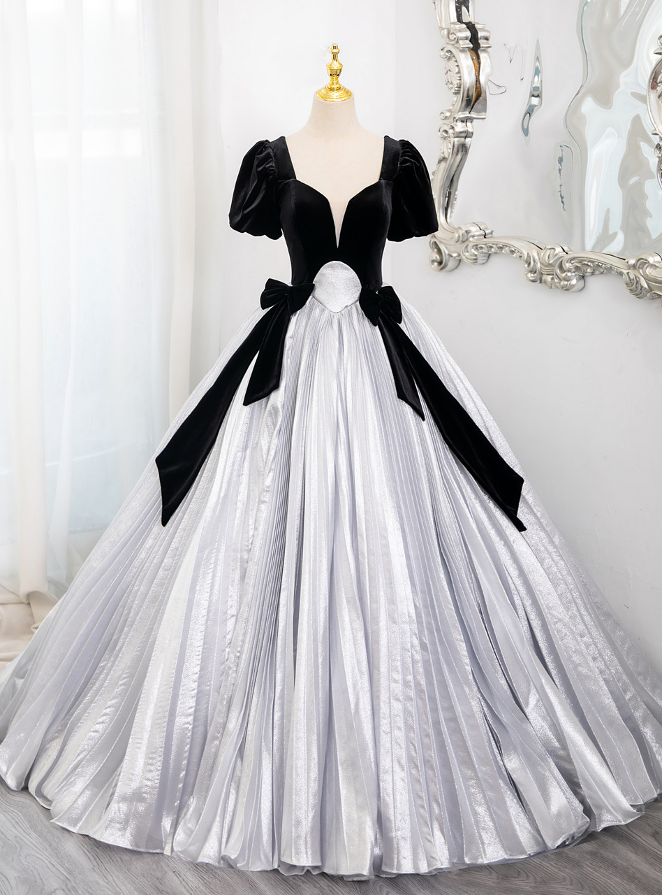 Black velvet and metallic silver Quinceanera dress with puff sleeves and pleated skirt