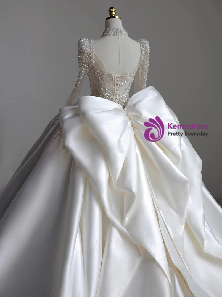 Jeweled high neck and long sleeve detail on white satin bridal gown