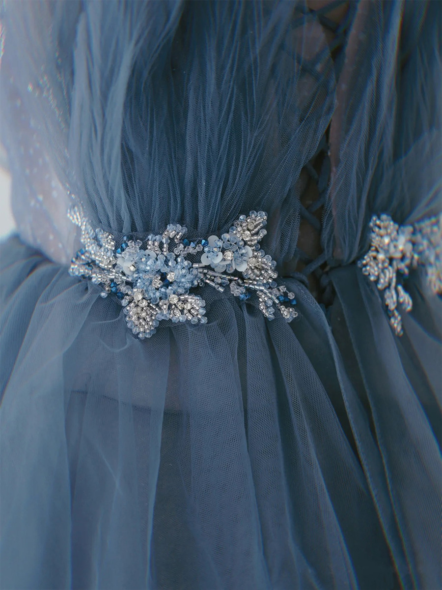 Dusty blue tulle prom dress with tiered skirt, crystal beaded waistband and delicate spaghetti straps