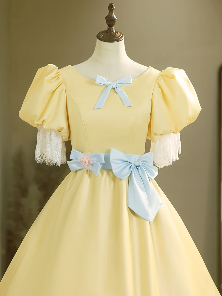 Yellow vintage ball gown with light blue waist bow, gathered skirt and white lace trim
