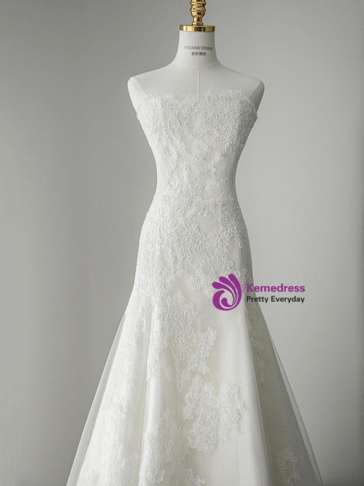 White lace wedding dress showing transition from floral bodice to layered tulle skirt