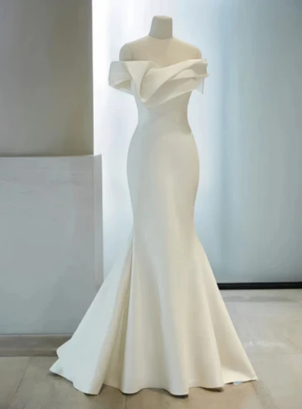 White mermaid wedding dress with sculptural off shoulder draping and fitted silhouette