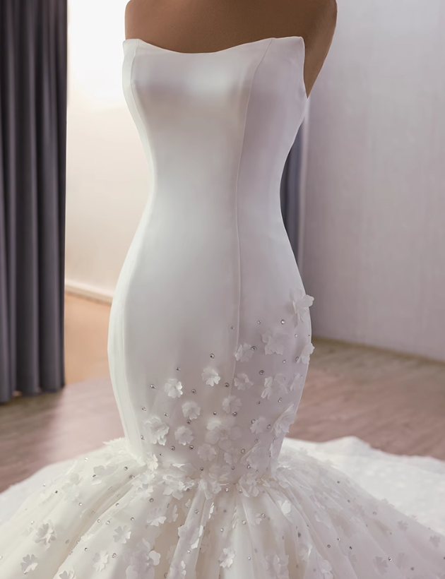 Floral details and tulle texture on a white strapless mermaid wedding dress