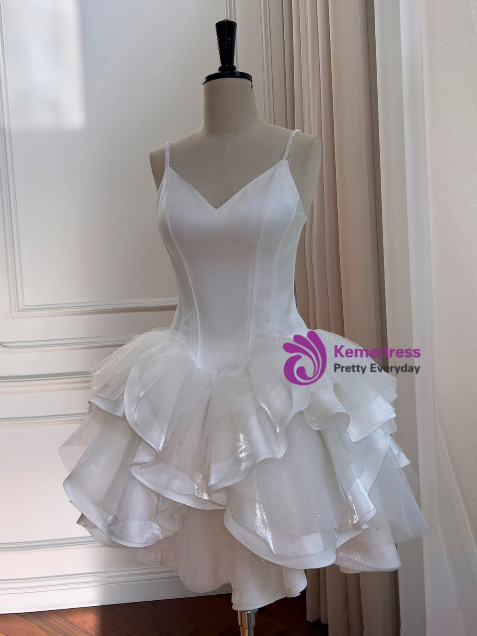 White tulle homecoming dress showing fitted bodice and sculptural ruffle skirt