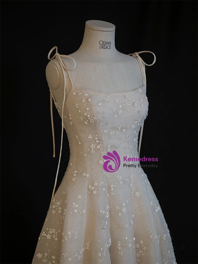 Short ivory formal dress with adjustable spaghetti straps and tea length A-line skirt