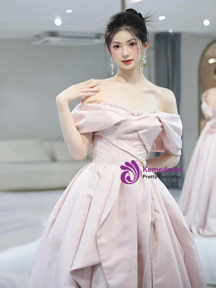 Pink prom dress detail with off shoulder neckline and pearl embellishment