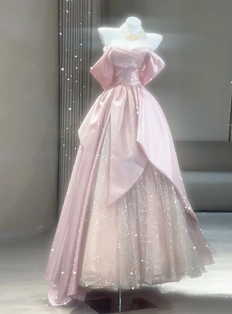 Pink tulle prom dress with oversized puff sleeves and off shoulder neckline