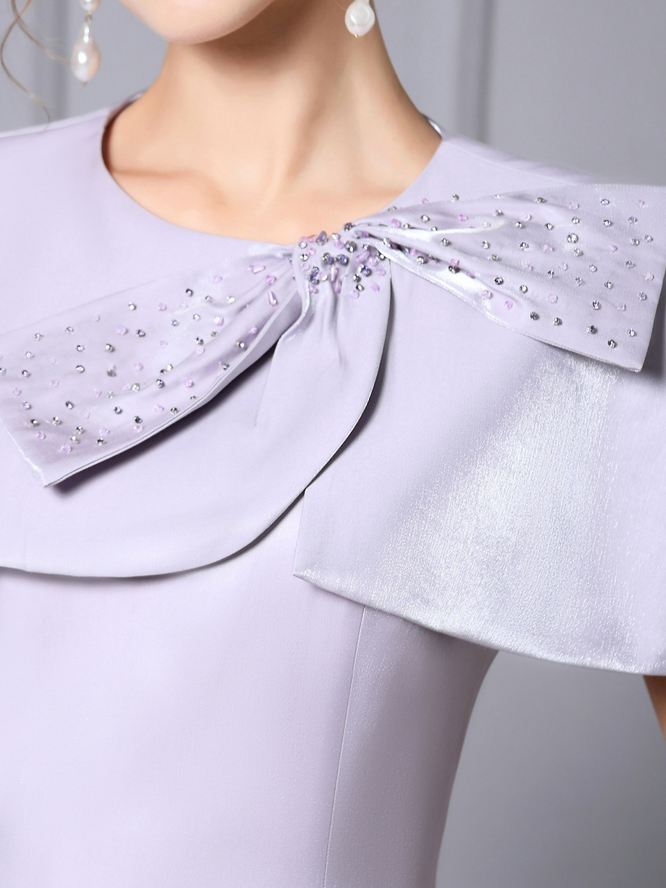 Purple satin mother of the bride dress with beaded bow detail