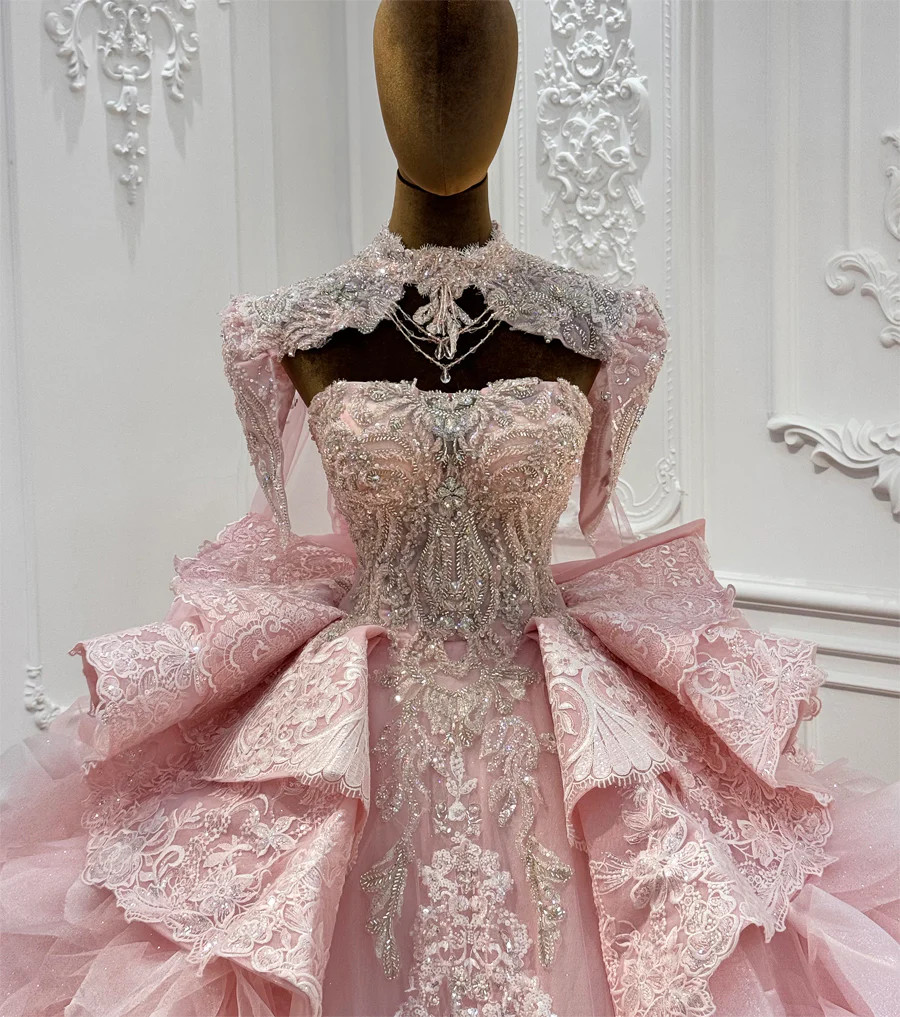 Pink tulle layers and appliqué detail on a princess ball gown