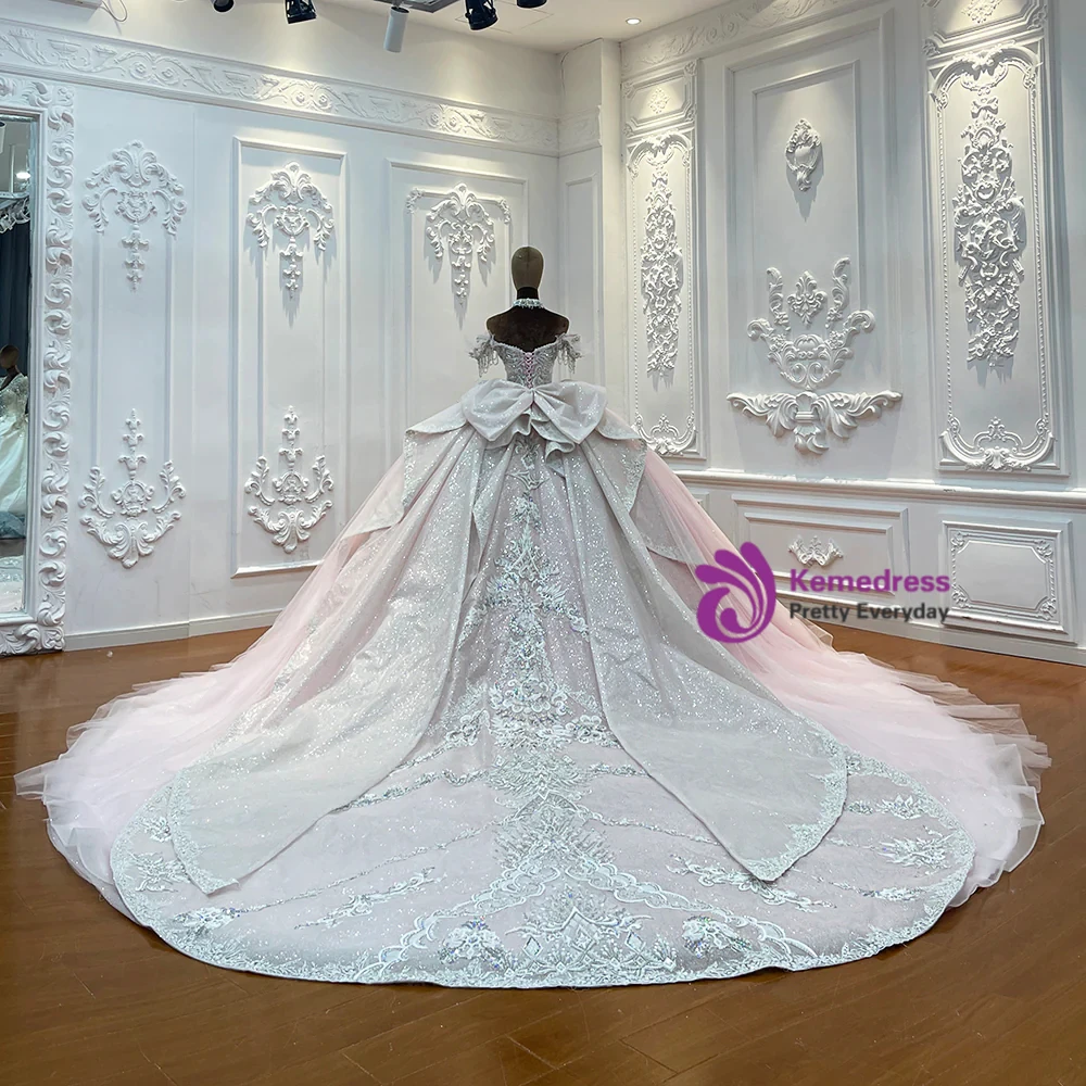 Full pink tulle ball gown with embellished bodice and lace up back