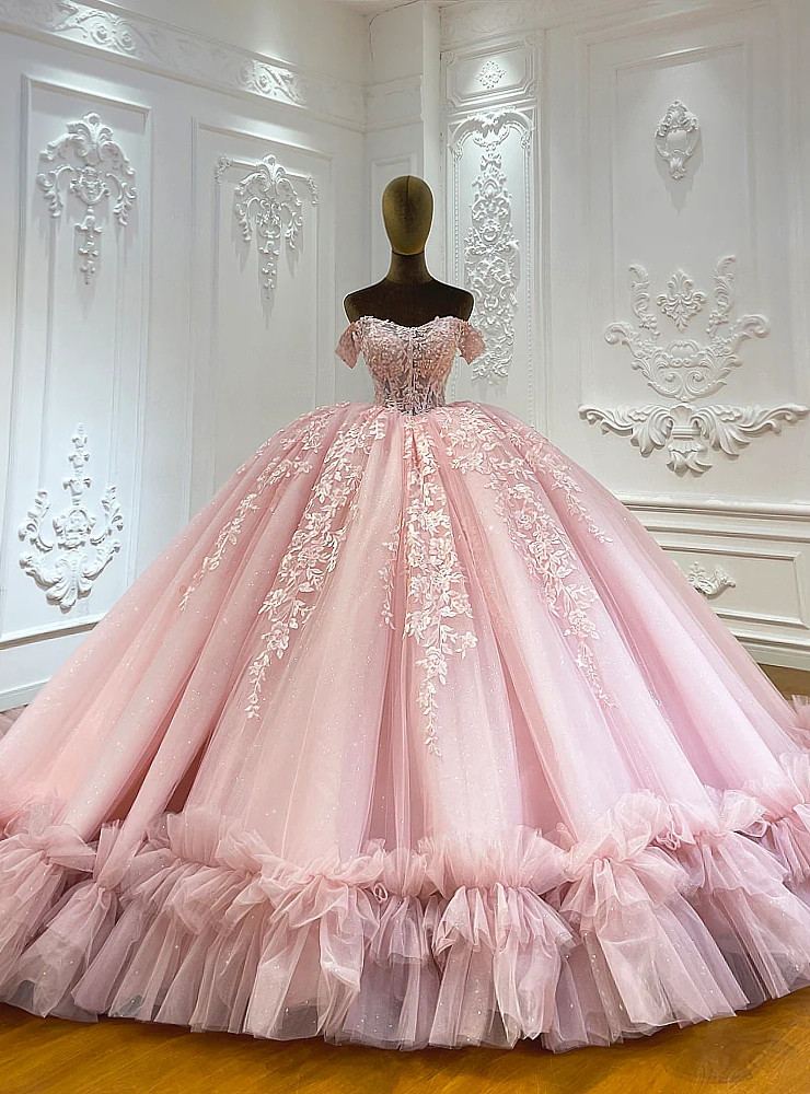 Pink tulle ball gown wedding dress with off shoulder bodice and ruffled hem