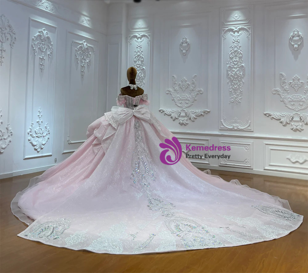 Pink tulle wedding gown with beaded appliqué surface and dramatic back detail