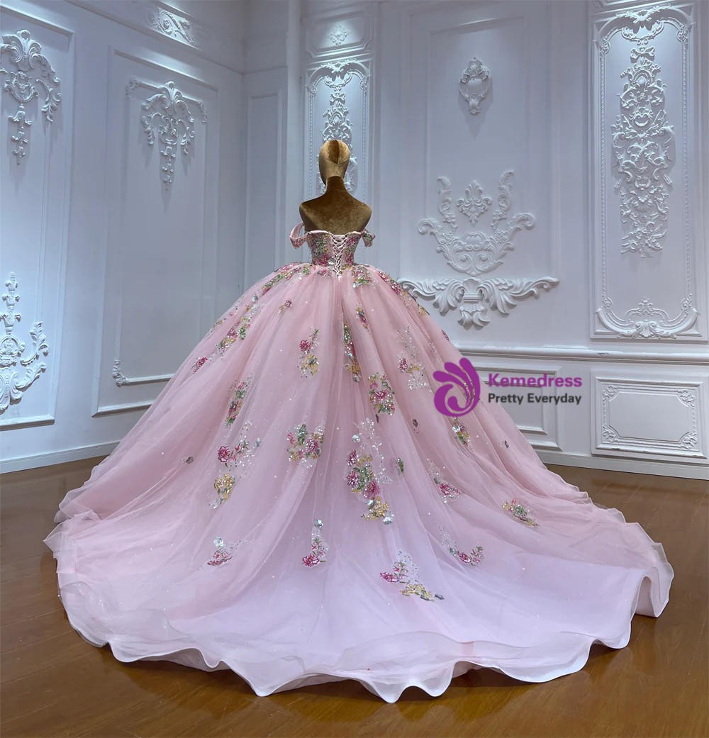 Close detail of colorful 3D floral appliques beads sequins and embroidery on pink tulle gown